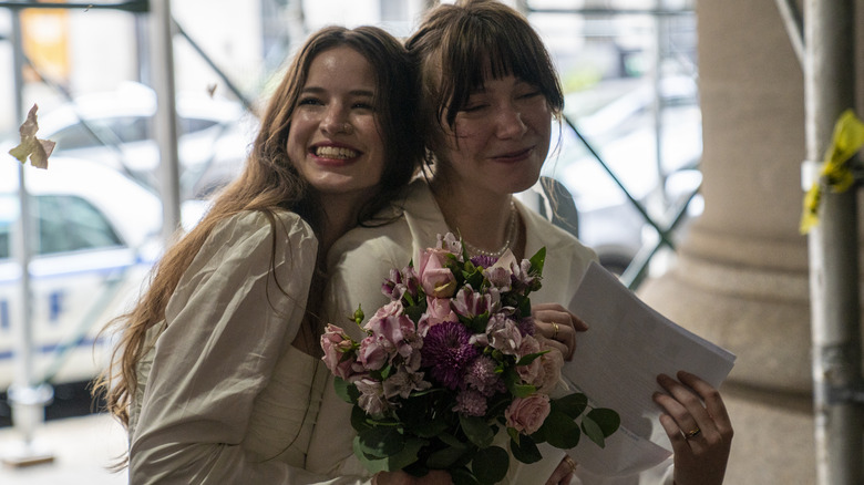 Newly wed couple smiles in city hall lobby