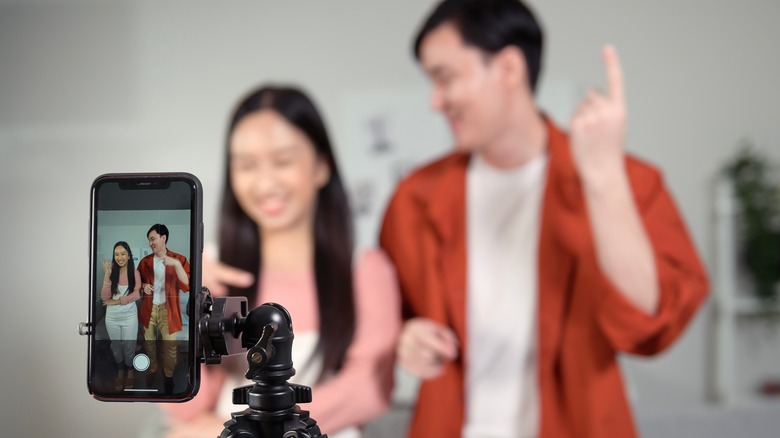 couple filming TikTok video 