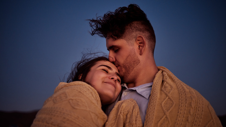 couple cuddling outside 