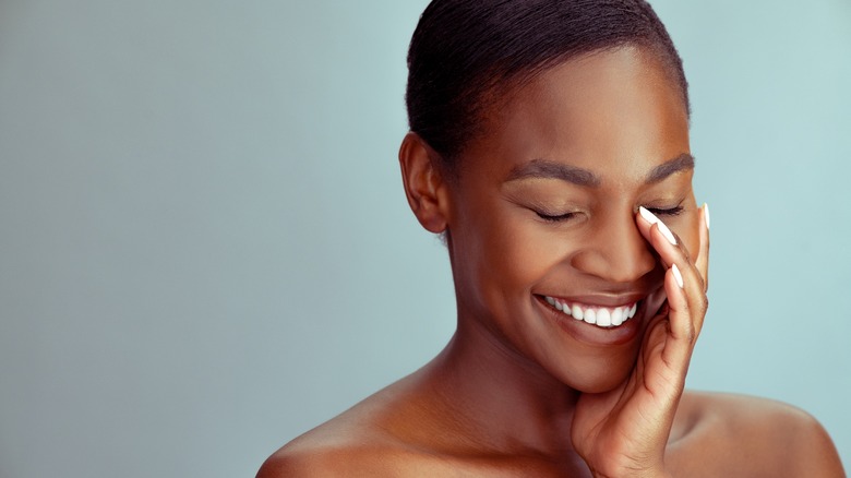 woman with fingers around eye