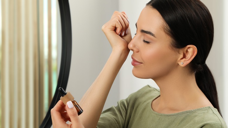 woman smelling perfume
