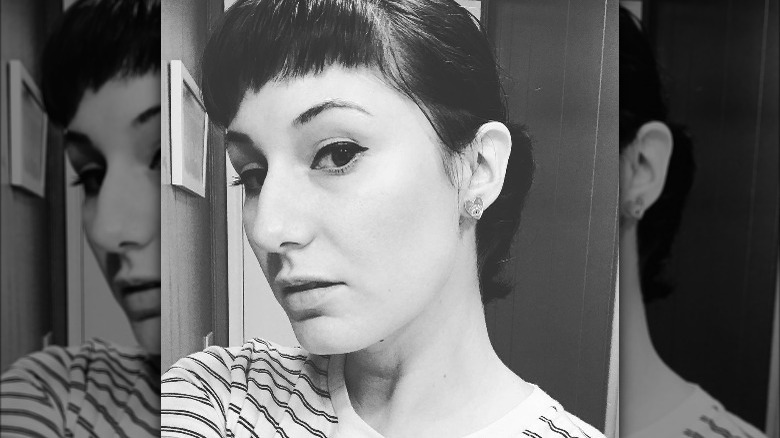 Woman poses with Hepburn bangs 