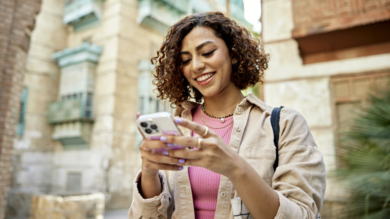 Woman holding phone away from face