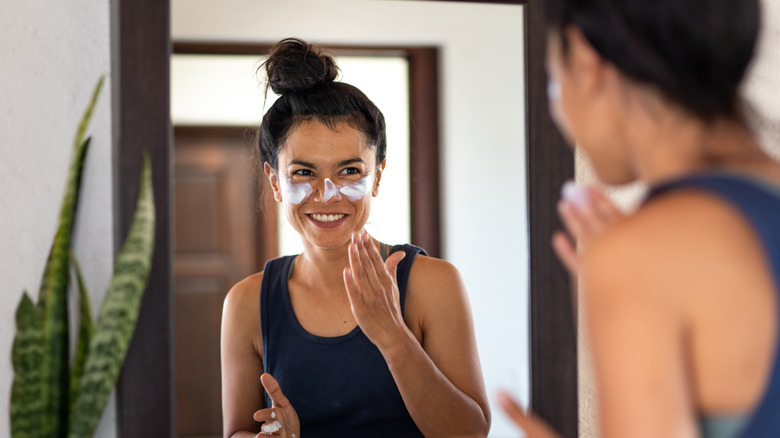 Woman applying sunscreen