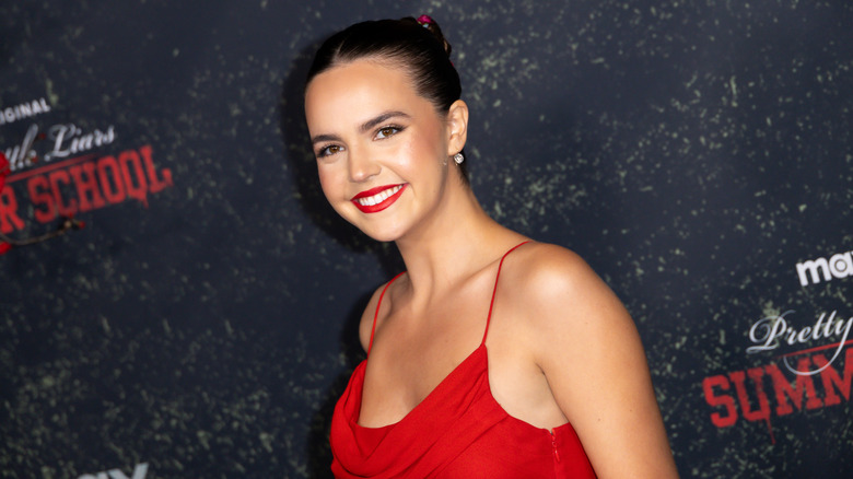 Bailee Madison wearing red on a red carpet