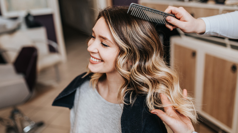 woman smiling with blond balayage