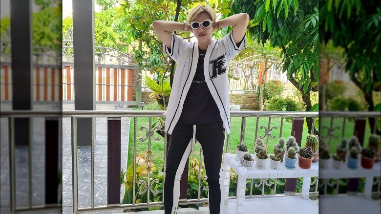 Woman wearing sunglasses with a baseball jersey