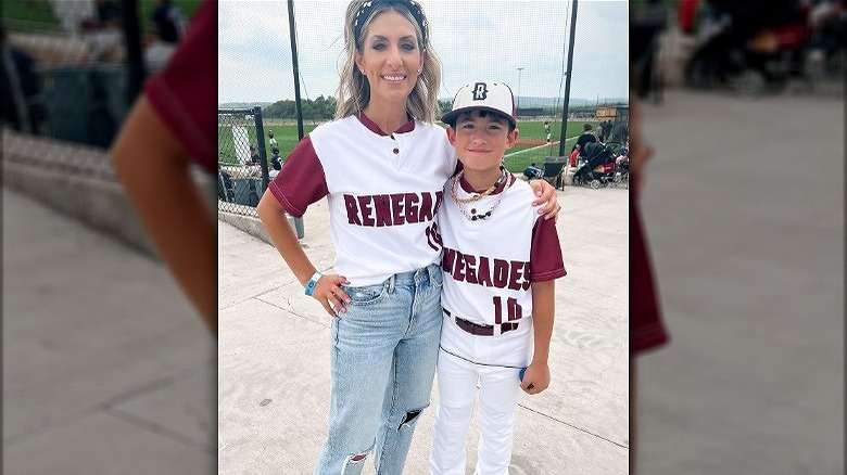 Woman wearing high waisted jeans with a baseball jersey