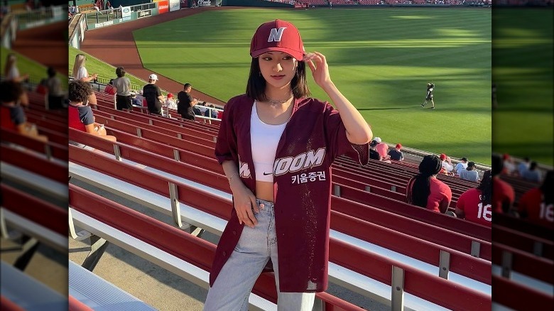 Woman wearing a baseball jersey with a tank top