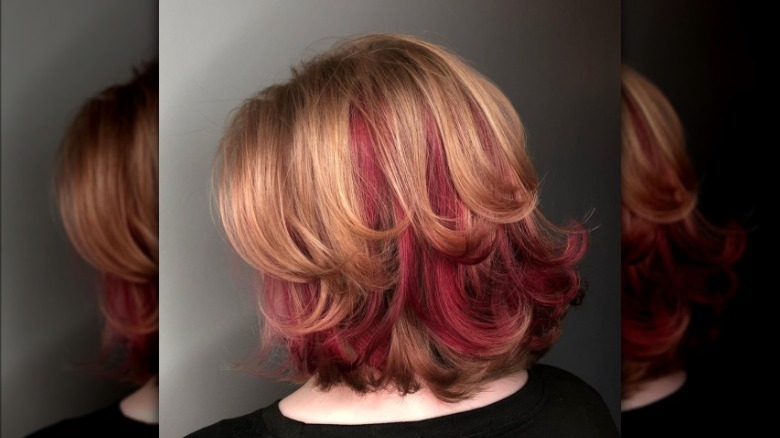 A woman with a red hair layer