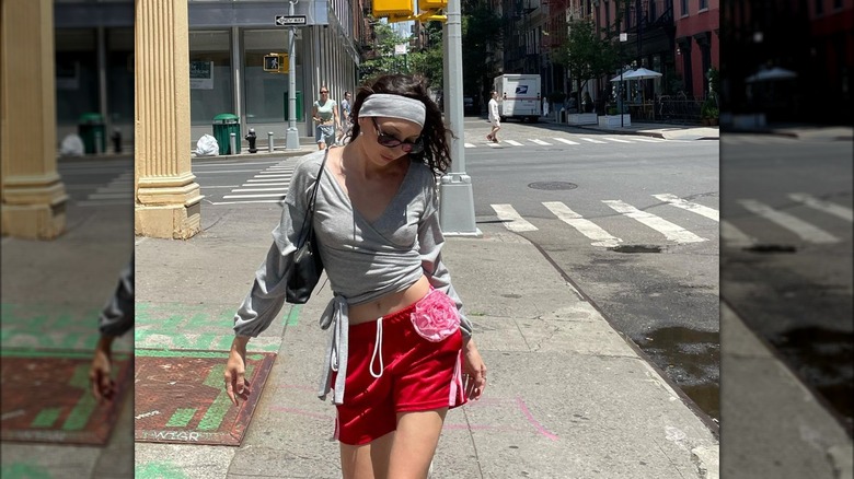 Woman wearing basketball shorts, wrap top