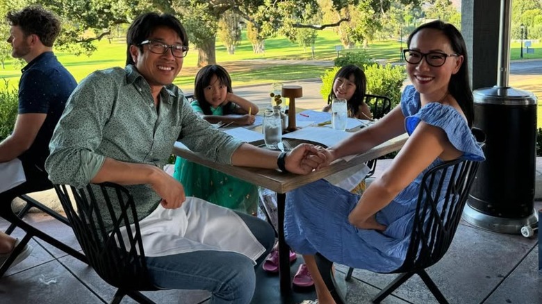 The Nguyen family smiling together at a table
