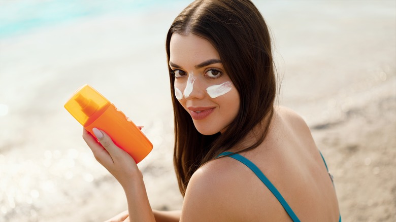 Woman at beach with sunscreen on