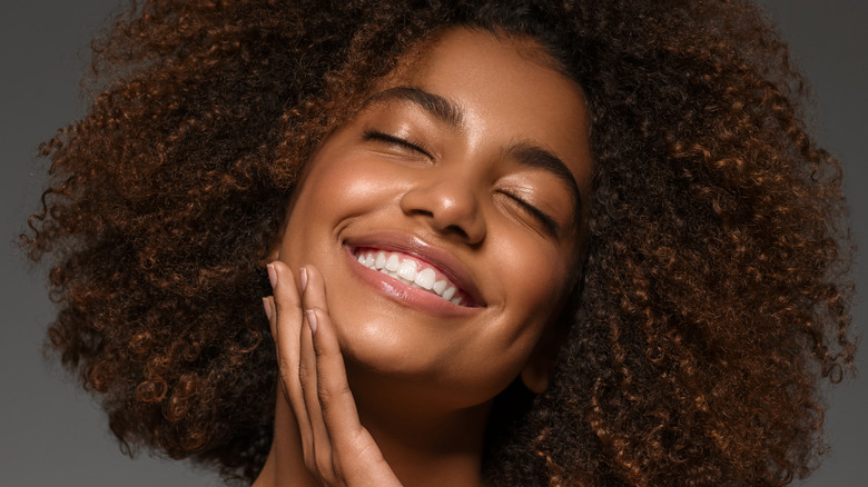 smiling Black woman with eyes closed