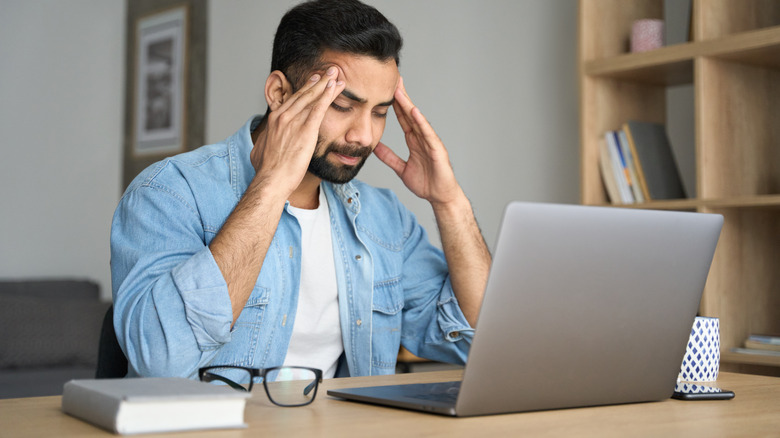 man feeling stressed at work