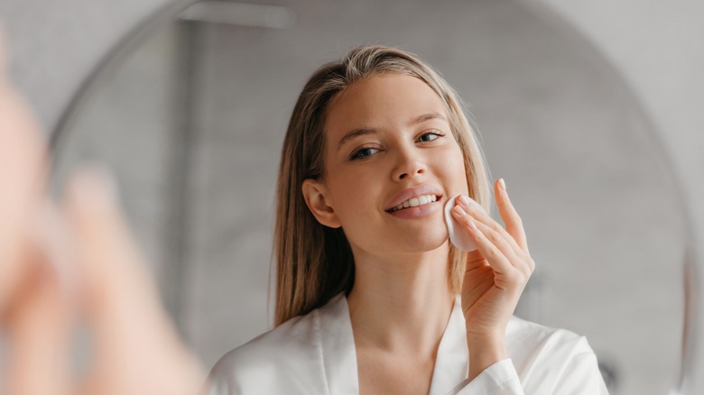 woman applying skincare product