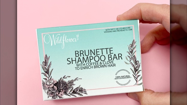 Person holding box with shampoo