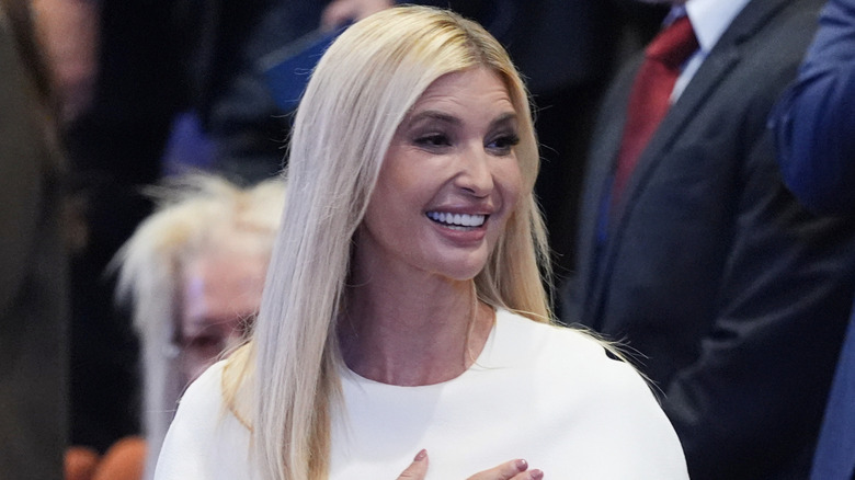 Ivanka Trump with her blond hair down, wearing a white dress