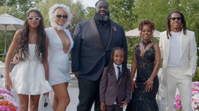 Beyoncé wearing a white dress and headpiece photographed at Rel Carter's wedding