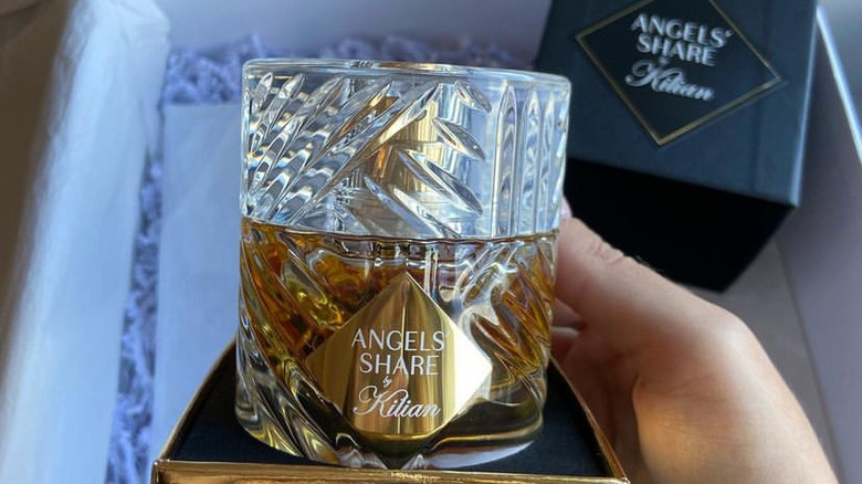 person holding Angels' Share perfume