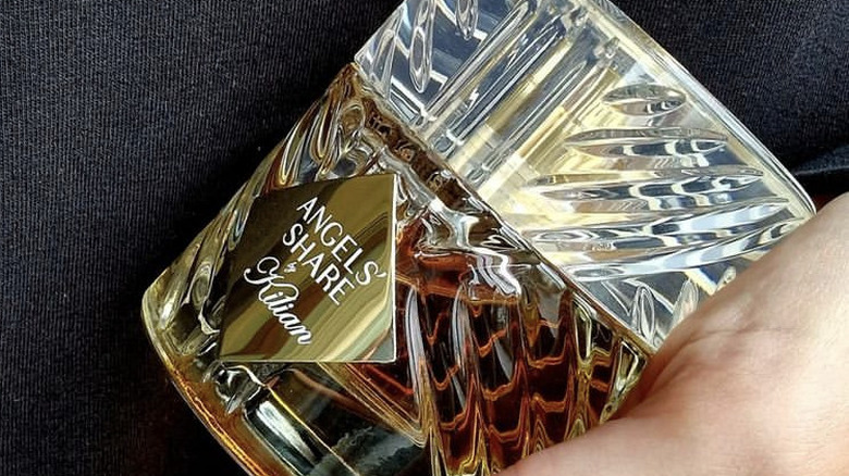 Angels' Share perfume bottle in hand