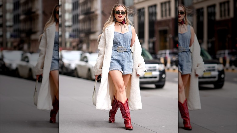 Woman wearing red cowboy boots with romper