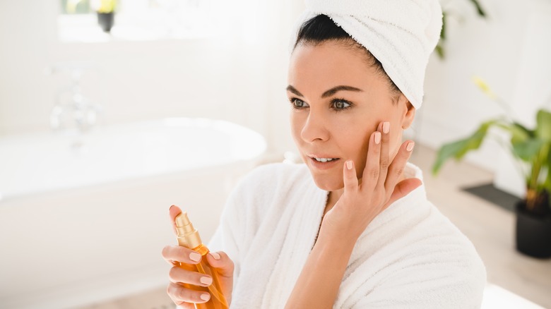 Woman holding skincare product