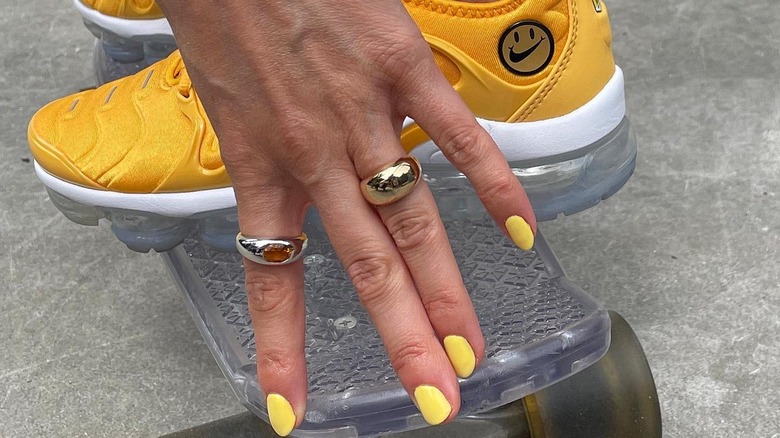 person wearing chunky silver jewelry