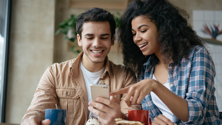 Friends smiling at phone