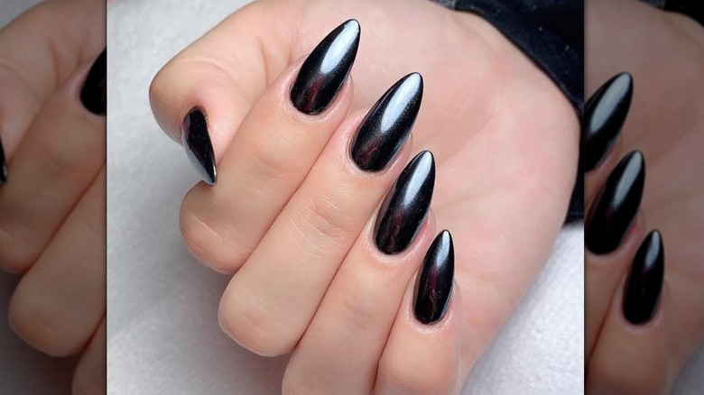 fingers with black chrome nails