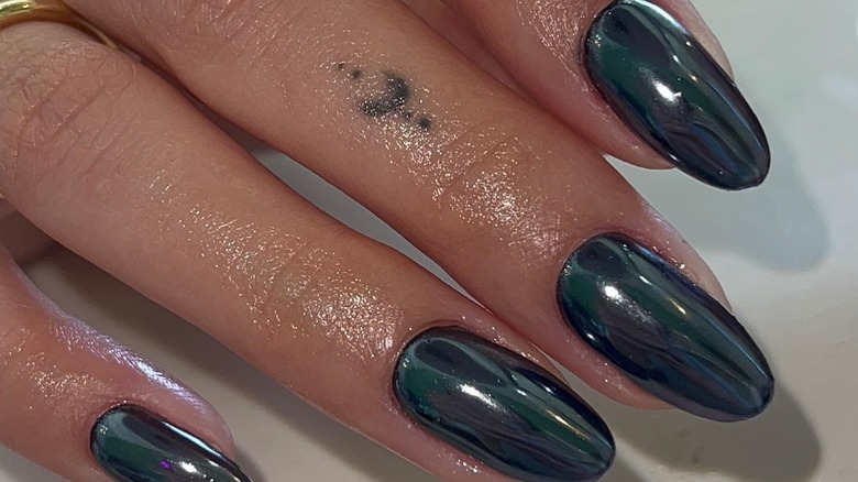 fingers with black chrome nails