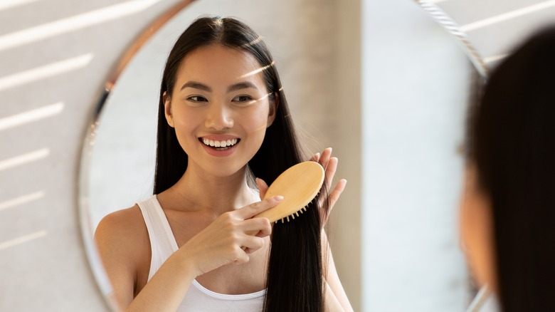 woman brushing her hair