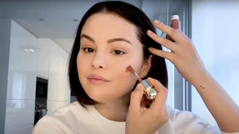 Selena Gomez applying blush