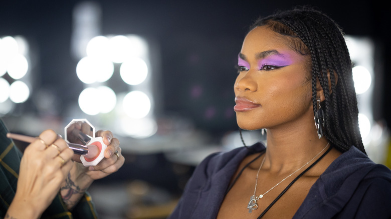 Savage X Fenty model getting makeup done