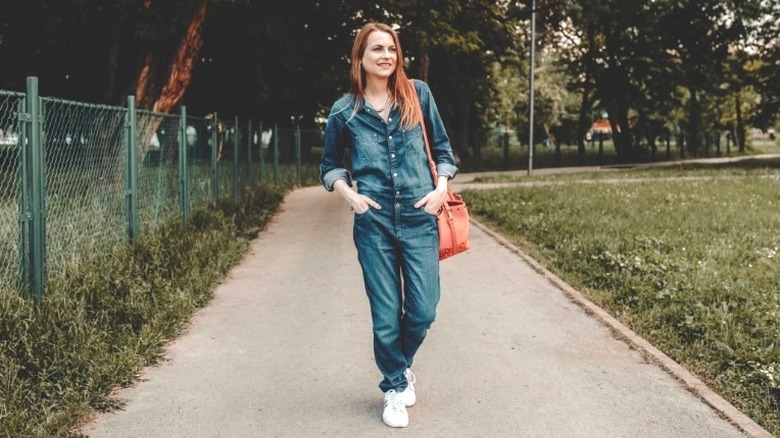 Woman wearing denim boiler suit jumpsuit