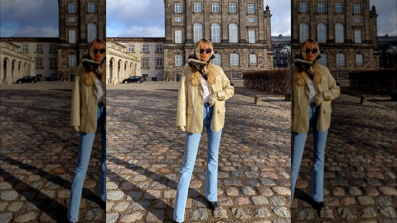 Girl wearing boot-cut denim with a blazer.