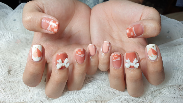 peachy square nails with bows