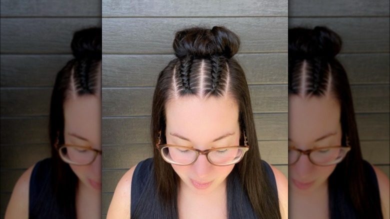 A woman with a braided top knot