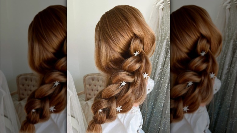A woman with a braid and hair jewelry