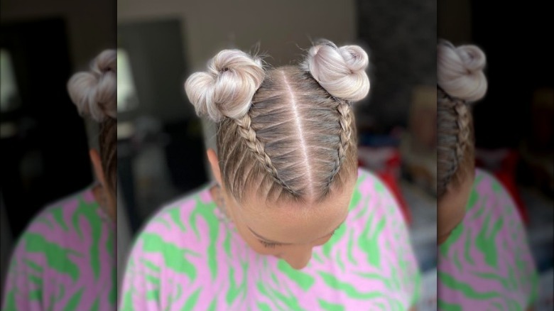 A woman with French braids and space buns