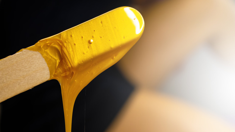 wax hanging from stick