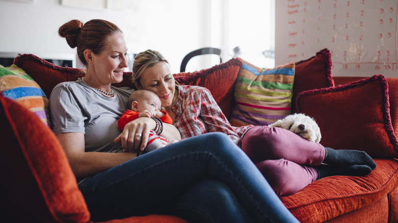 Couple and baby resting on couch