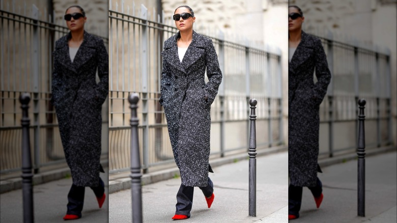 Woman wearing wool coat and red heels