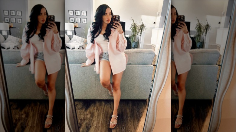 woman wearing sweat shorts under blouse