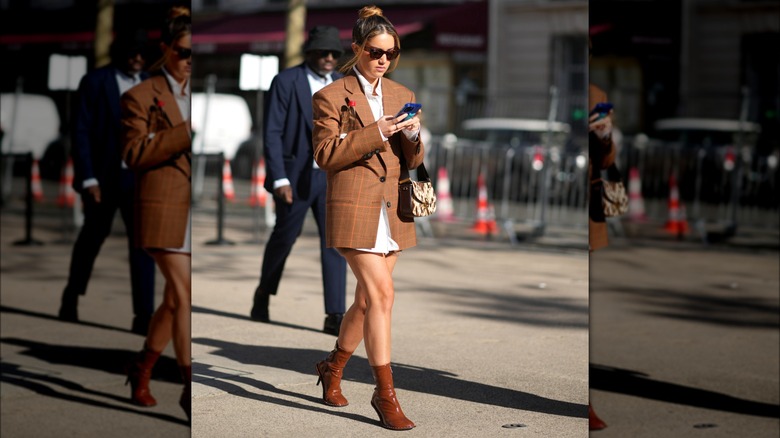 Woman wearing brown plaid blazer and boots