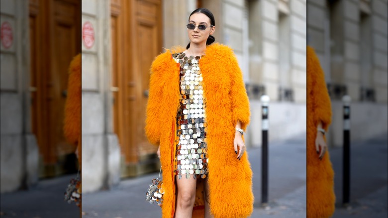 Woman wearing fuzzy orange coat