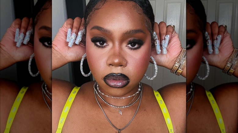 Girl wearing smudged black eyeliner.