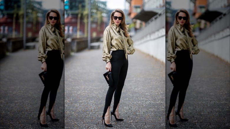 Woman wearing gold shirt, black stirrups