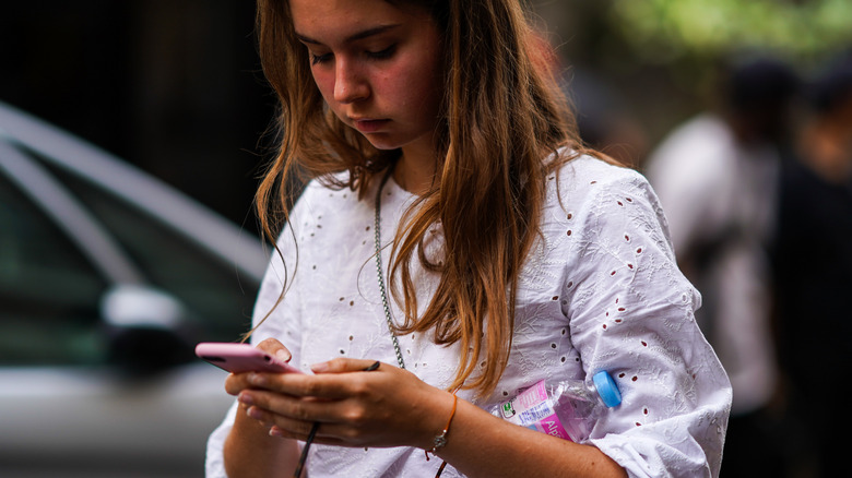 woman wearing broderie anglaise top