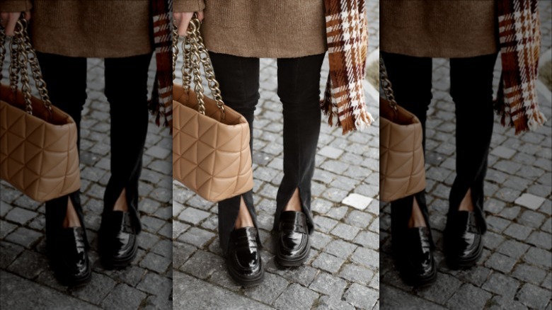 Woman wears brown sweater and black pants